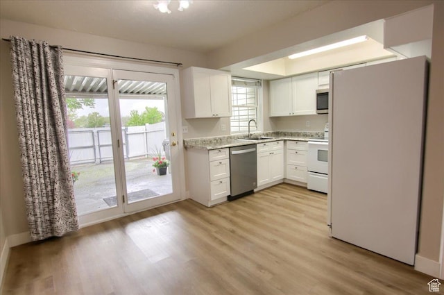 571 N 200 W, Bountiful, UT 84010 - kitchen featuring a sink, appliances with stainless steel finishes, white cabinetry, baseboards, and light wood-style floors