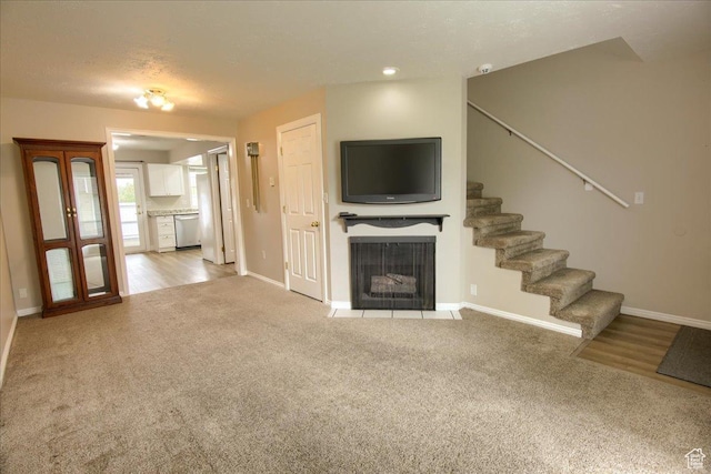 571 N 200 W, Bountiful, UT 84010 - unfurnished living room with stairway, light carpet, baseboards, and a fireplace with flush hearth