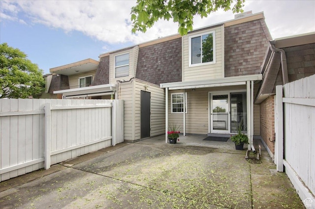 571 N 200 W, Bountiful, UT 84010 - back of property featuring roof with shingles, fence, a patio, and mansard roof