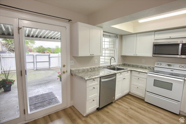 571 N 200 W, Bountiful, UT 84010 - kitchen featuring white cabinets, appliances with stainless steel finishes, light wood-style flooring, and a sink