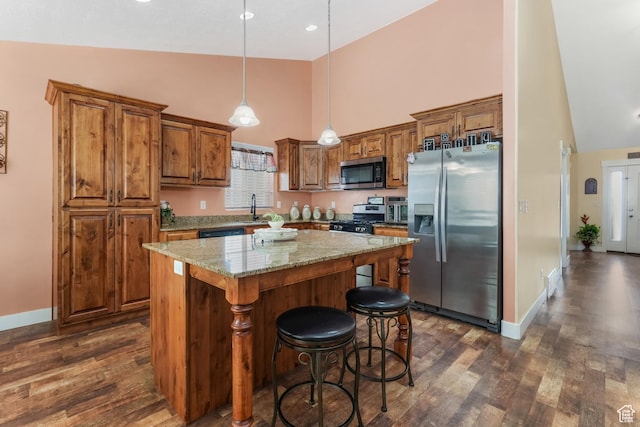 4999 W Tobago Ln, Herriman, UT 84096 - kitchen with stainless steel appliances, brown cabinets, dark wood-style floors, and high vaulted ceiling