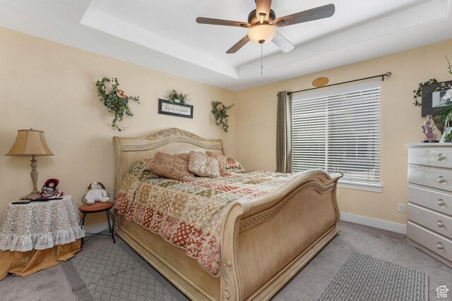 4999 W Tobago Ln, Herriman, UT 84096 - bedroom featuring baseboards, a tray ceiling, a ceiling fan, and carpet floors