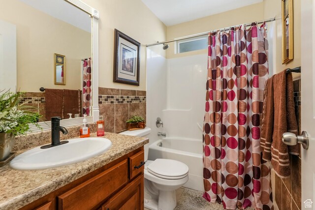 4999 W Tobago Ln, Herriman, UT 84096 - full bath with tile walls, shower / tub combo, toilet, vanity, and a wainscoted wall