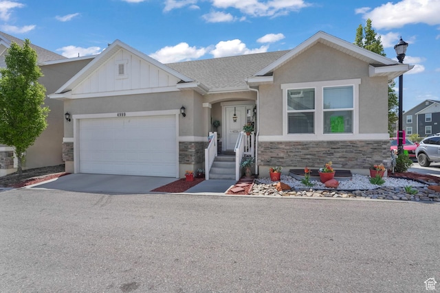 4999 W Tobago Ln, Herriman, UT 84096 - view of front of property featuring driveway, board and batten siding, an attached garage, stucco siding, and stone siding