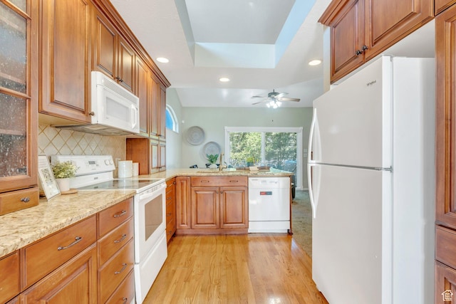 12532 S Blacksmith Ln, Draper, UT 84020 - kitchen with a sink, a peninsula, white appliances, light wood-type flooring, and recessed lighting