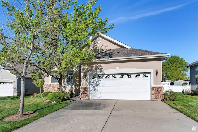 12532 S Blacksmith Ln, Draper, UT 84020 - view of front of property featuring stone siding, an attached garage, stucco siding, concrete driveway, and a front yard