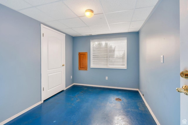 12532 S Blacksmith Ln, Draper, UT 84020 - unfurnished room with finished concrete floors, baseboards, and a paneled ceiling