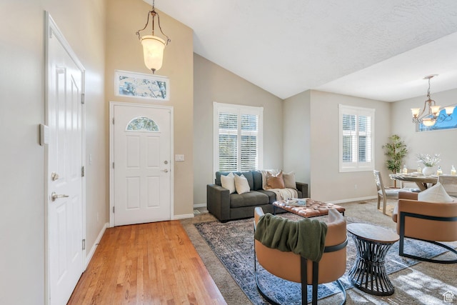 12532 S Blacksmith Ln, Draper, UT 84020 - entrance foyer featuring an inviting chandelier, light wood-style flooring, baseboards, and plenty of natural light
