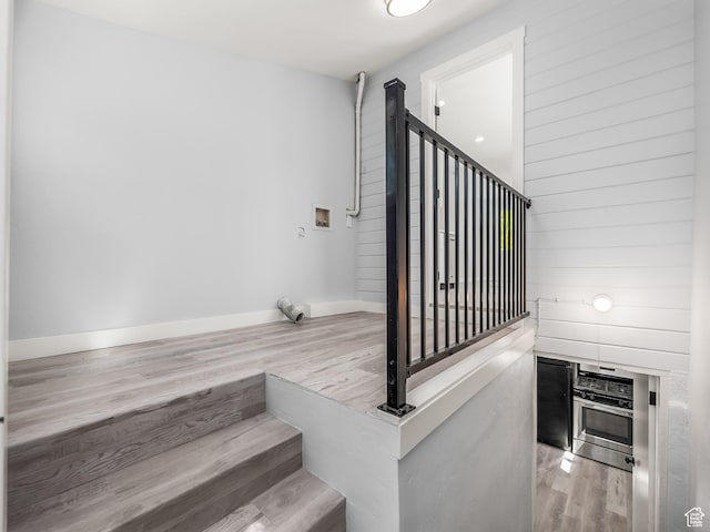 staircase with wood finished floors and baseboards