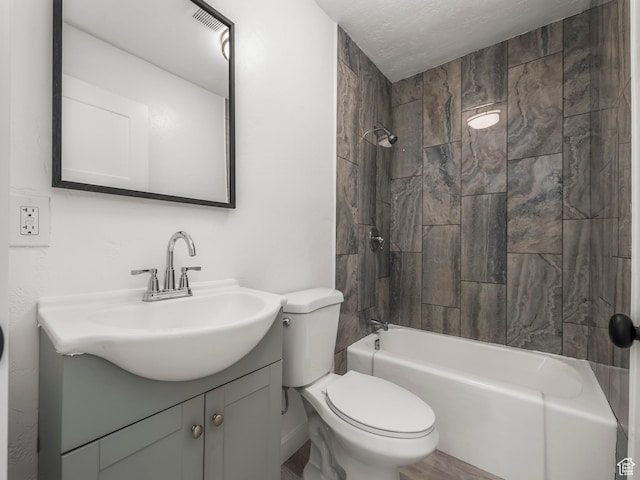 bathroom featuring toilet, wood finished floors, vanity, and washtub / shower combination