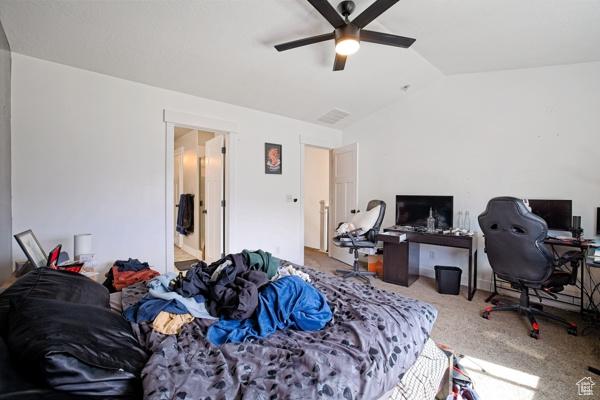 carpeted bedroom with lofted ceiling and a ceiling fan