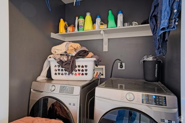 clothes washing area with washer and dryer and laundry area