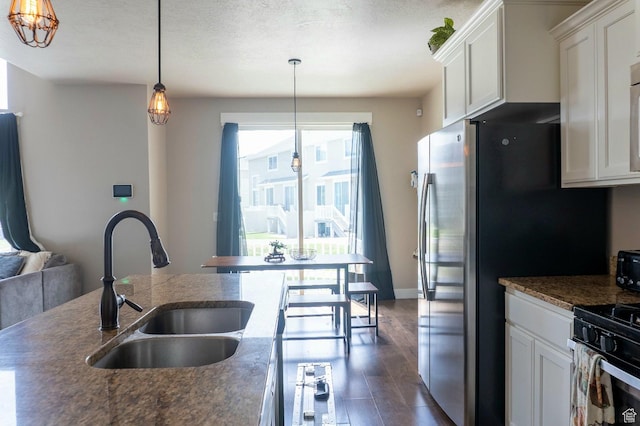 954 S 2040 W, Orem, UT 84059 - kitchen with dark wood-style floors, white cabinets, hanging light fixtures, and a textured ceiling