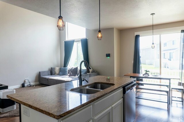 954 S 2040 W, Orem, UT 84059 - kitchen featuring stainless steel dishwasher, decorative light fixtures, a textured ceiling, an island with sink, and open floor plan