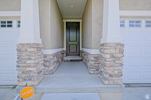 954 S 2040 W, Orem, UT 84059 - doorway to property featuring stucco siding, stone siding, and a garage