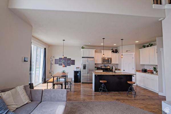 living room with recessed lighting and wood finished floors