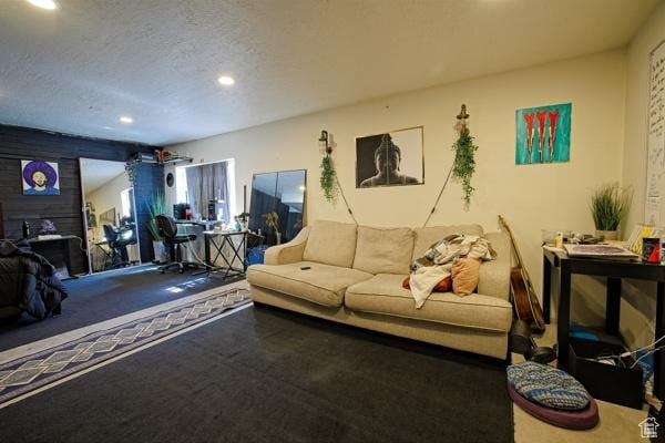 living room featuring recessed lighting and a textured ceiling