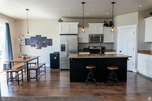 954 S 2040 W, Orem, UT 84059 - kitchen featuring stainless steel appliances, recessed lighting, an island with sink, white cabinets, and light stone counters