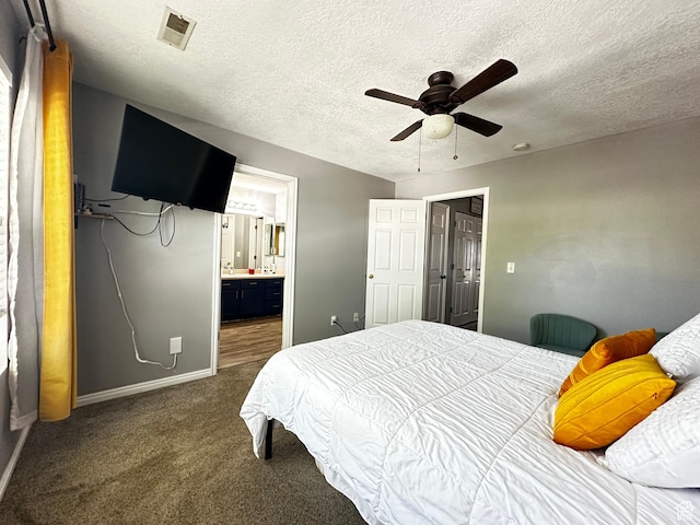 bedroom featuring baseboards, dark carpet, visible vents, and a textured ceiling
