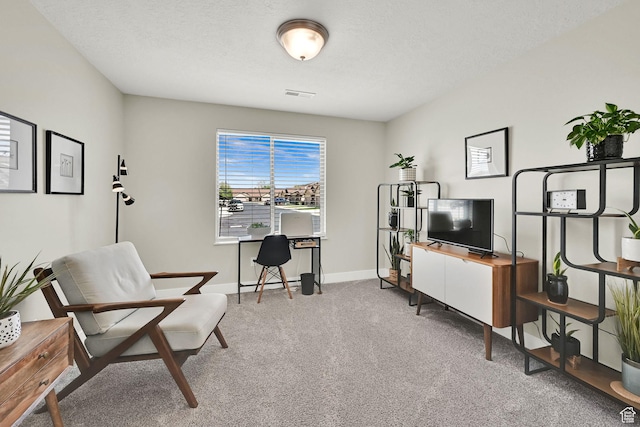 carpeted office featuring baseboards and visible vents