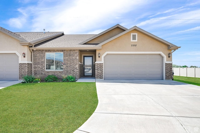 view of front of property with driveway, brick siding, a front lawn, and a garage