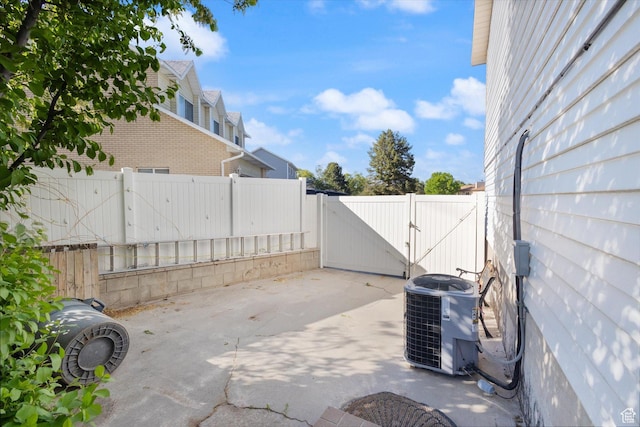 4990 S Hensley Cir, Taylorsville, UT 84129 - view of patio / terrace featuring cooling unit, a fenced backyard, and a gate