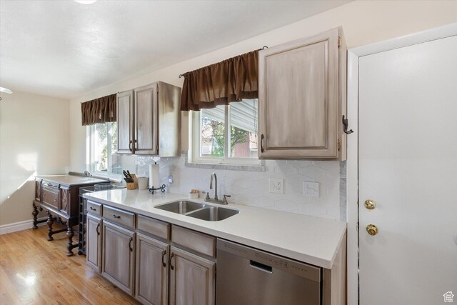 4990 S Hensley Cir, Taylorsville, UT 84129 - kitchen with a sink, stainless steel dishwasher, a wealth of natural light, and light wood-type flooring