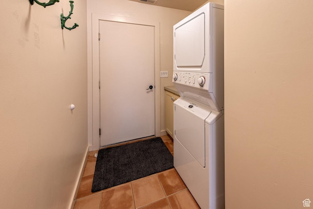 3686 S Spanish Valley Dr Unit K-2, Moab, UT 84532 - clothes washing area featuring baseboards, cabinet space, stacked washer / dryer, and light tile patterned flooring