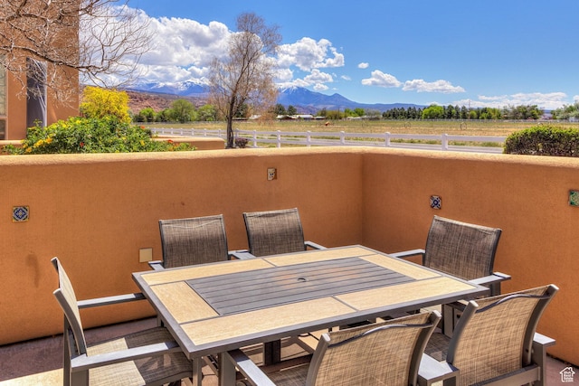3686 S Spanish Valley Dr Unit K-2, Moab, UT 84532 - view of patio / terrace with a rural view, outdoor dining space, a mountain view, and fence