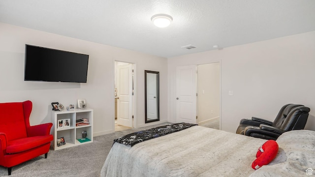 bedroom featuring baseboards, a textured ceiling, visible vents, and carpet floors