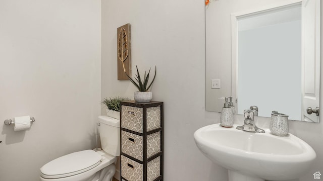 half bath with a sink and toilet