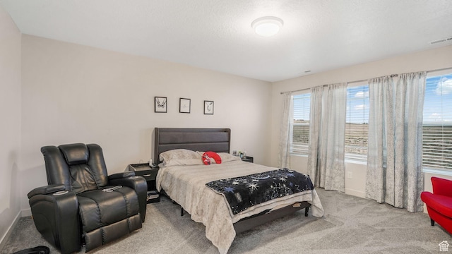 bedroom featuring light carpet, baseboards, and visible vents