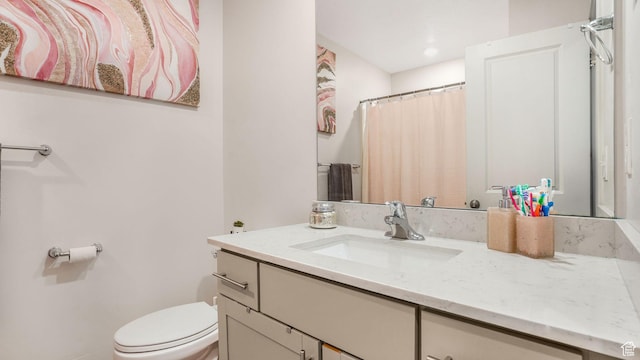 bathroom featuring toilet and vanity