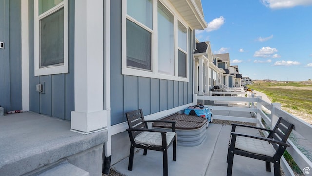 view of patio featuring a balcony and a residential view