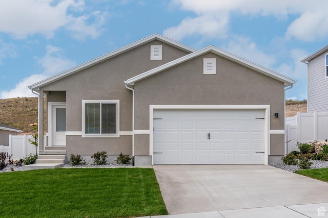 single story home featuring driveway, stucco siding, a front lawn, and an attached garage