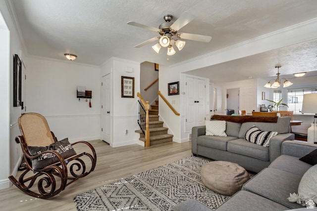 747 N 200 E, Springville, UT 84663 - living room featuring ceiling fan with notable chandelier, ornamental molding, light wood-type flooring, stairway, and baseboards
