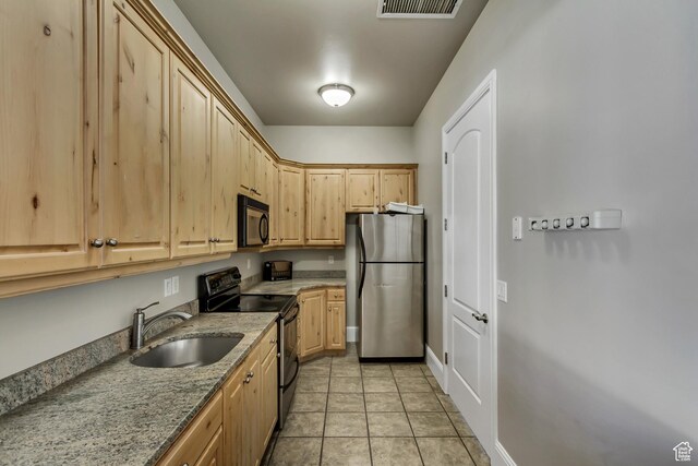 747 N 200 E, Springville, UT 84663 - kitchen featuring light brown cabinets, light tile patterned floors, light stone counters, a sink, and stainless steel appliances