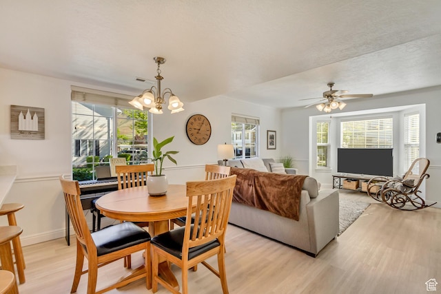 747 N 200 E, Springville, UT 84663 - dining room with light wood-style flooring, visible vents, plenty of natural light, and ceiling fan with notable chandelier