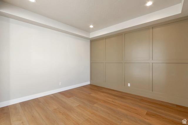 514 S 1450 W, Farmington, UT 84025 - unfurnished room with a decorative wall, light wood finished floors, recessed lighting, baseboards, and a tray ceiling