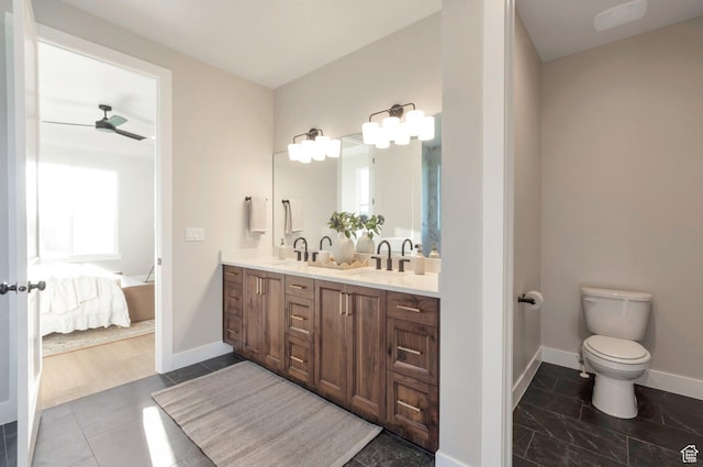 514 S 1450 W, Farmington, UT 84025 - bathroom with baseboards, ensuite bathroom, double vanity, toilet, and ceiling fan
