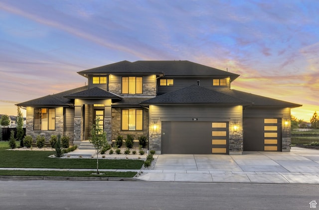 514 S 1450 W, Farmington, UT 84025 - prairie-style home with stone siding, an attached garage, driveway, a lawn, and a shingled roof