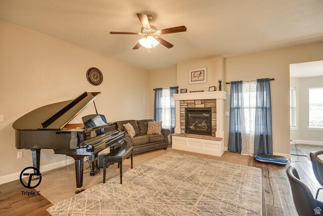 249 E 1800 N, Beaver, UT 84713 - living room featuring ceiling fan, a stone fireplace, wood finished floors, and baseboards