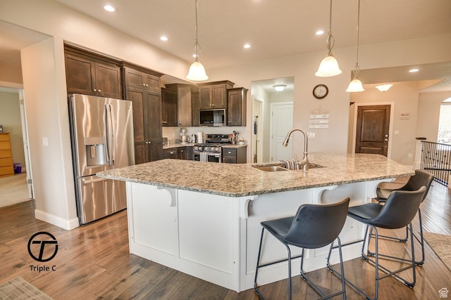 249 E 1800 N, Beaver, UT 84713 - kitchen with appliances with stainless steel finishes, a sink, dark brown cabinets, dark wood-style flooring, and a kitchen breakfast bar