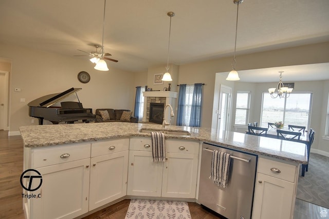 249 E 1800 N, Beaver, UT 84713 - kitchen featuring dishwasher, a sink, open floor plan, a fireplace, and dark wood-style floors