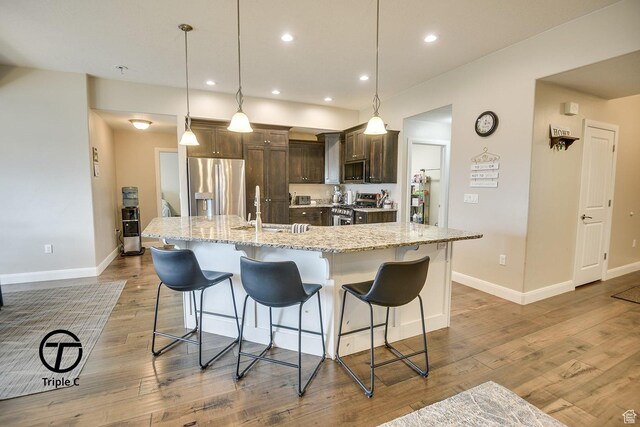249 E 1800 N, Beaver, UT 84713 - kitchen with stainless steel appliances, dark brown cabinets, a sink, a kitchen bar, and recessed lighting