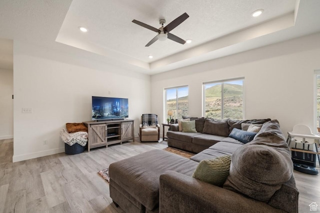 12735 W Kimberly Cir, Tremonton, UT 84337 - living room with light wood finished floors, a ceiling fan, a raised ceiling, and recessed lighting