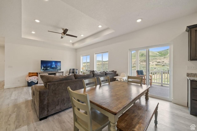 12735 W Kimberly Cir, Tremonton, UT 84337 - dining space with a raised ceiling, a ceiling fan, and light wood-style floors