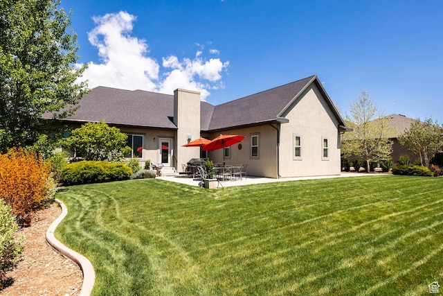65 W Carnesecca Ct N, Mapleton, UT 84664 - rear view of house with a patio, stucco siding, a chimney, and a lawn