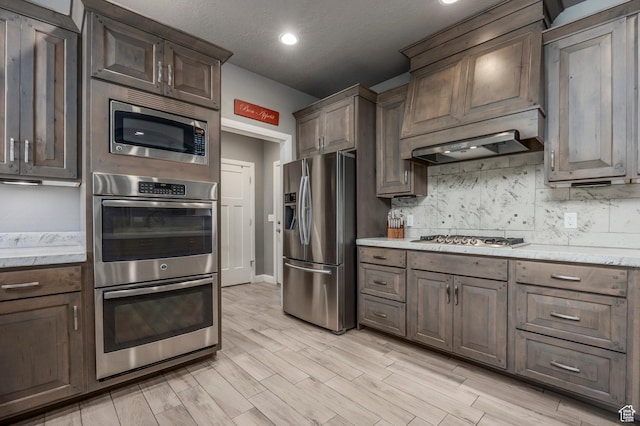65 W Carnesecca Ct N, Mapleton, UT 84664 - kitchen with light wood finished floors, recessed lighting, stainless steel appliances, and backsplash