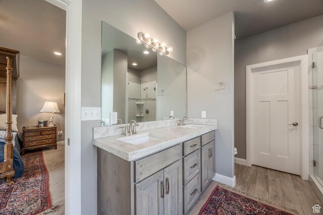 65 W Carnesecca Ct N, Mapleton, UT 84664 - full bathroom featuring double vanity, wood finished floors, a stall shower, and a sink